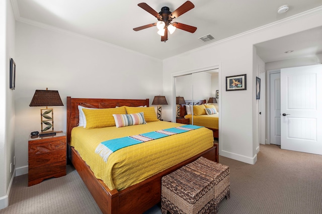 carpeted bedroom featuring ceiling fan, a closet, and ornamental molding