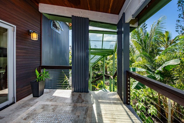 unfurnished sunroom with wood ceiling and beam ceiling