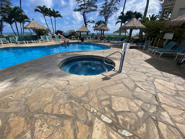 view of pool with a gazebo, a patio, and a hot tub