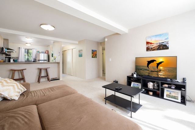 living room featuring beam ceiling and light carpet