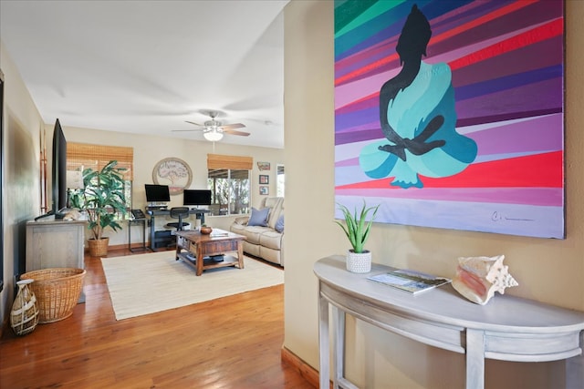 living room with hardwood / wood-style floors and ceiling fan