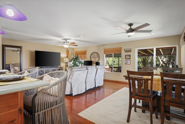 living room featuring ceiling fan and wood-type flooring