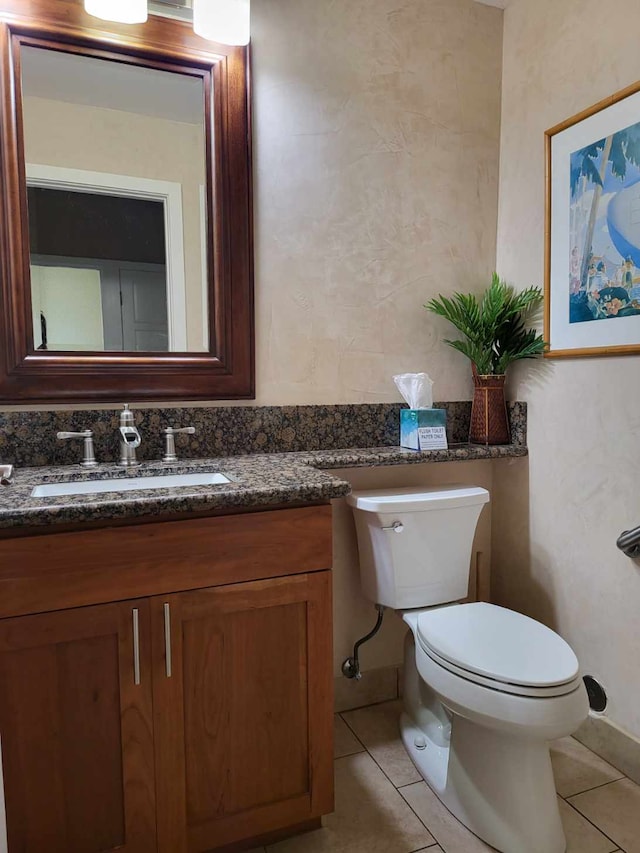 bathroom with vanity, tile patterned floors, and toilet