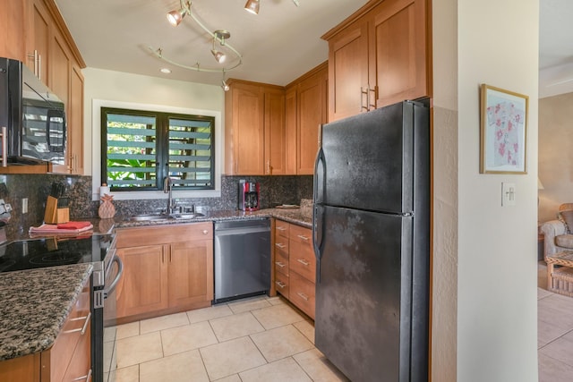 kitchen with light tile patterned flooring, appliances with stainless steel finishes, tasteful backsplash, sink, and dark stone counters