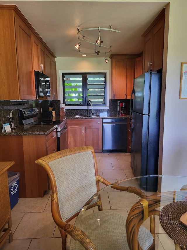 kitchen featuring sink, decorative backsplash, black appliances, and light tile patterned flooring