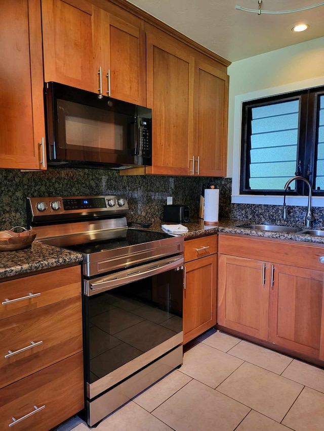 kitchen with sink, backsplash, dark stone counters, and stainless steel range with electric stovetop