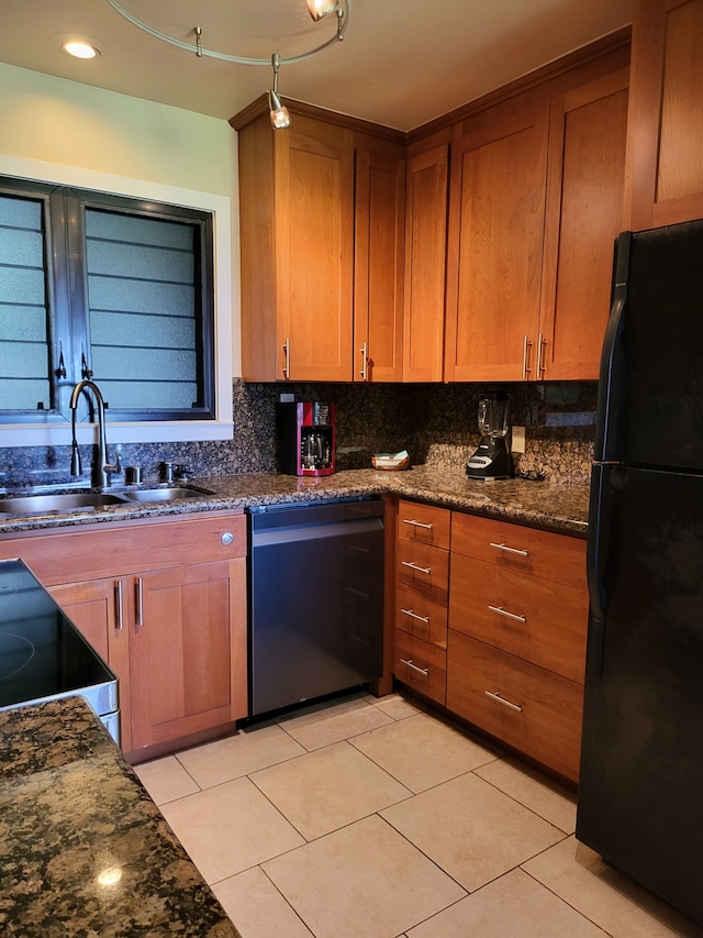 kitchen featuring range with electric stovetop, light tile patterned flooring, black refrigerator, dishwasher, and sink