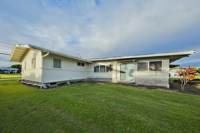 back of house with a yard