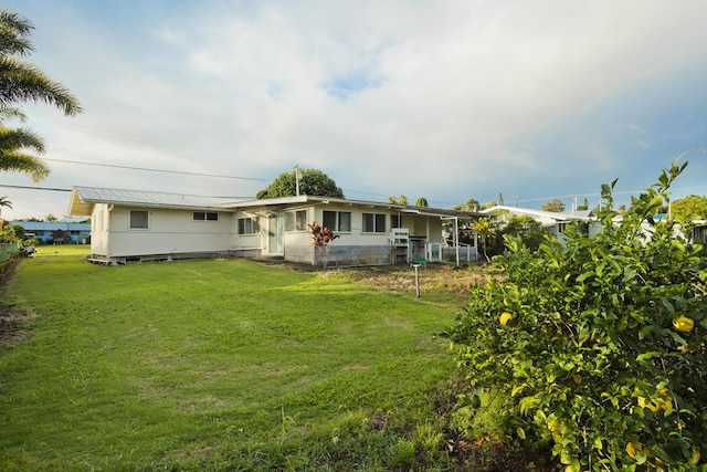 rear view of property with a yard