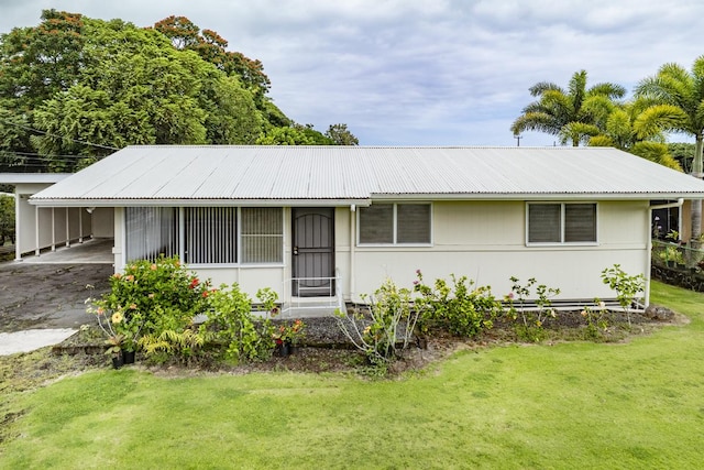 ranch-style home with a front yard and a carport