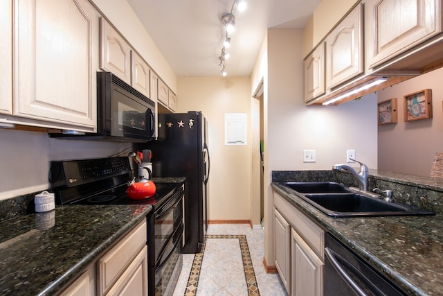 kitchen featuring rail lighting, dark stone counters, sink, black appliances, and light tile patterned flooring