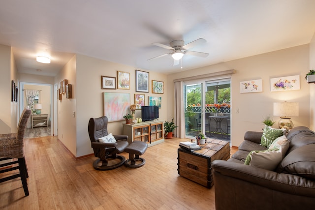 living room with ceiling fan and light hardwood / wood-style flooring