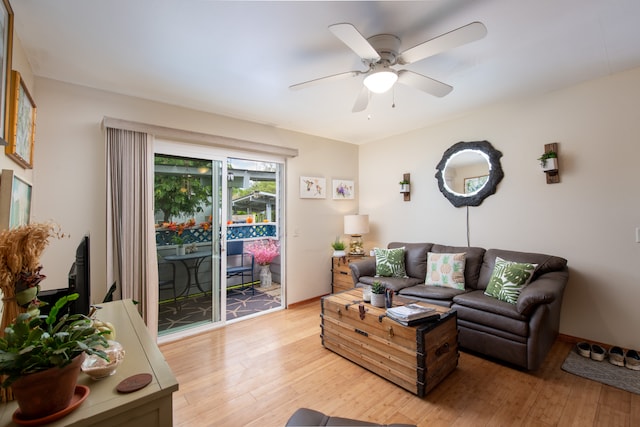 living room featuring hardwood / wood-style floors and ceiling fan