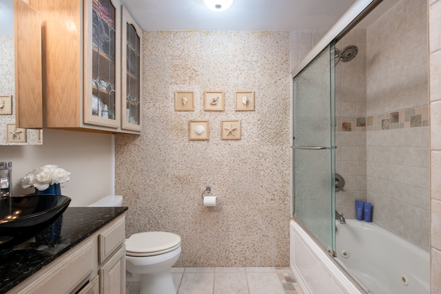 full bathroom with tile patterned floors, shower / bath combination with glass door, tile walls, and toilet