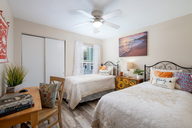 bedroom featuring ceiling fan, light hardwood / wood-style floors, and a closet