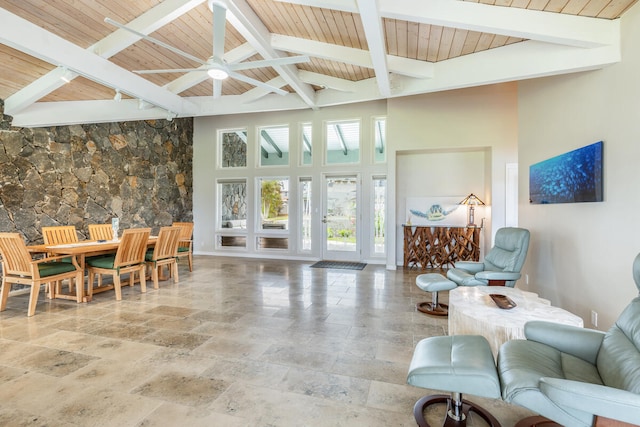 interior space featuring beamed ceiling, a towering ceiling, ceiling fan, and wood ceiling