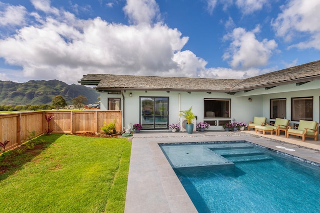 rear view of house featuring a fenced in pool, a yard, outdoor lounge area, a patio area, and a mountain view