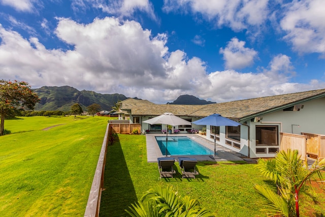 view of pool featuring a lawn, a mountain view, and a patio