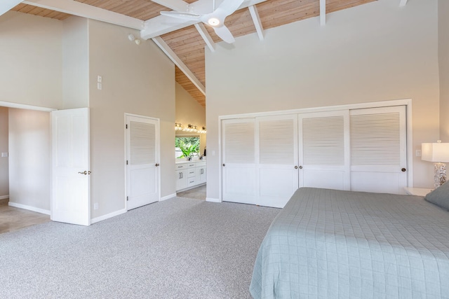 unfurnished bedroom with carpet floors, high vaulted ceiling, beamed ceiling, wooden ceiling, and ceiling fan