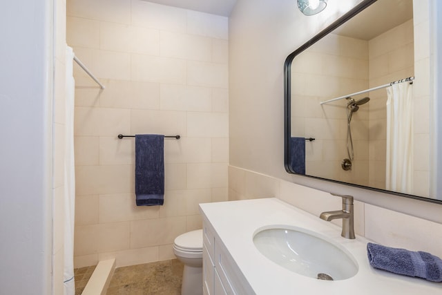 bathroom with toilet, tile patterned floors, tile walls, vanity, and walk in shower