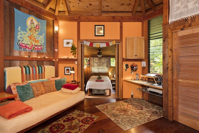 living area with wooden walls, lofted ceiling with beams, wooden ceiling, and dark wood-type flooring