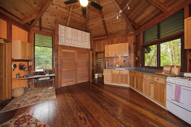 kitchen with wood walls, dark wood-type flooring, ceiling fan, white gas range, and wood ceiling