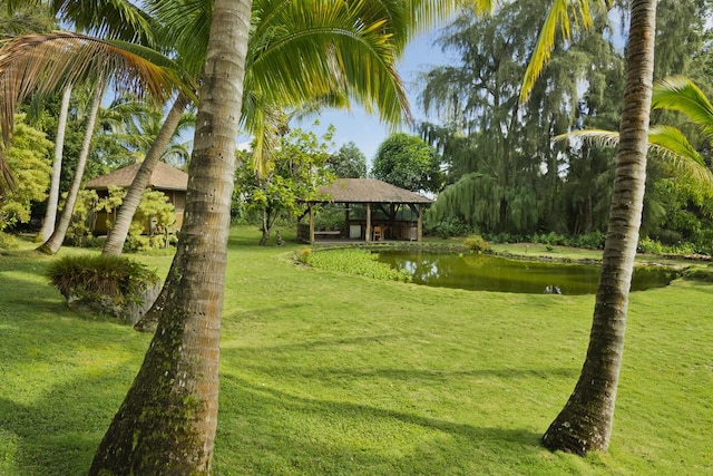 view of property's community featuring a gazebo, a yard, and a water view