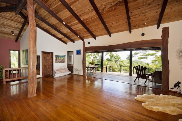 unfurnished living room with wood-type flooring, beam ceiling, high vaulted ceiling, and wood ceiling