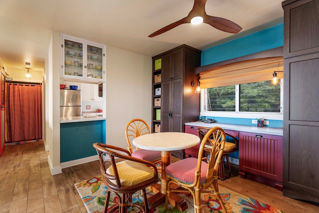 dining space featuring ceiling fan and light wood-type flooring