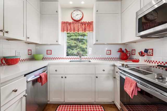 kitchen featuring sink, white cabinetry, and stainless steel appliances