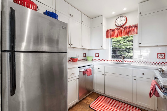 kitchen featuring white cabinets, light hardwood / wood-style floors, sink, and appliances with stainless steel finishes