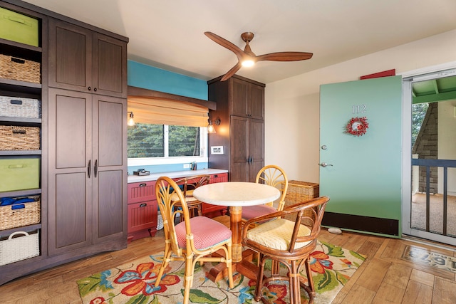 dining room with ceiling fan and light wood-type flooring