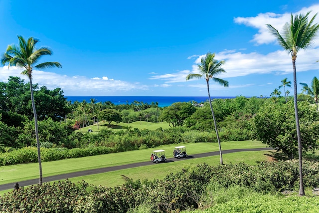 view of property's community with a yard and a water view