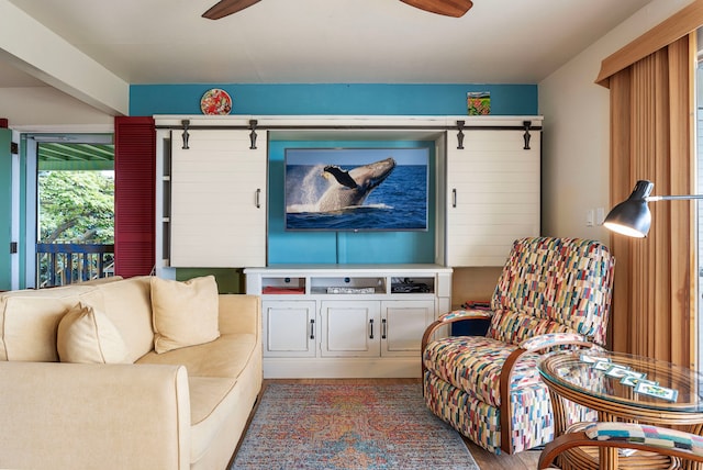 living room with ceiling fan and wood-type flooring