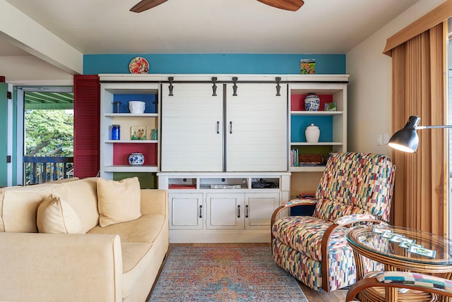 living room featuring ceiling fan and hardwood / wood-style flooring