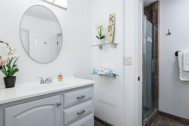 bathroom featuring vanity and a shower with door