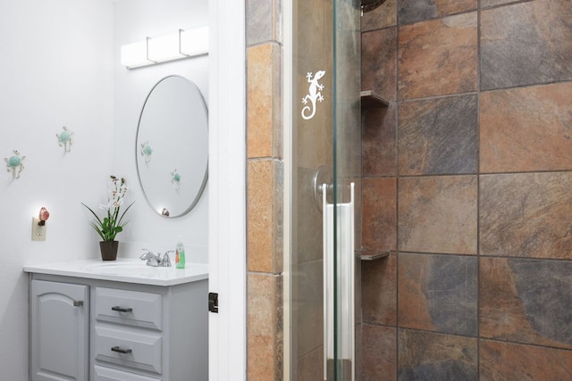 bathroom featuring walk in shower and vanity