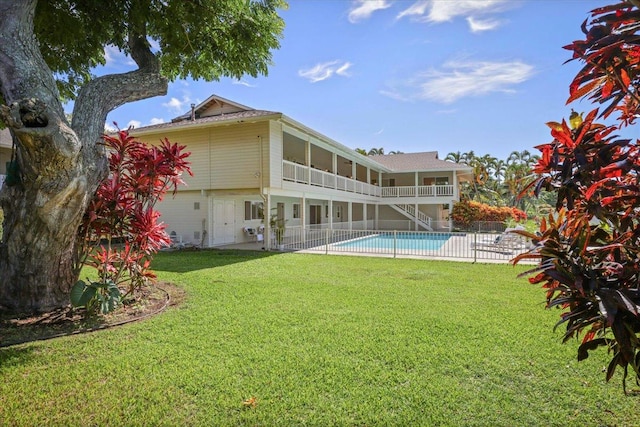 rear view of property featuring a patio and a lawn