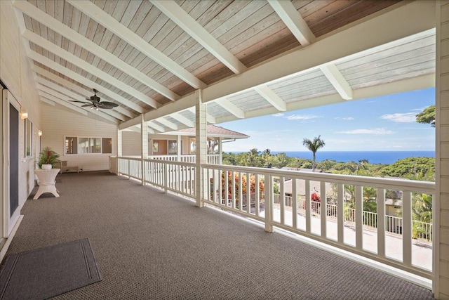 view of patio featuring a water view and ceiling fan