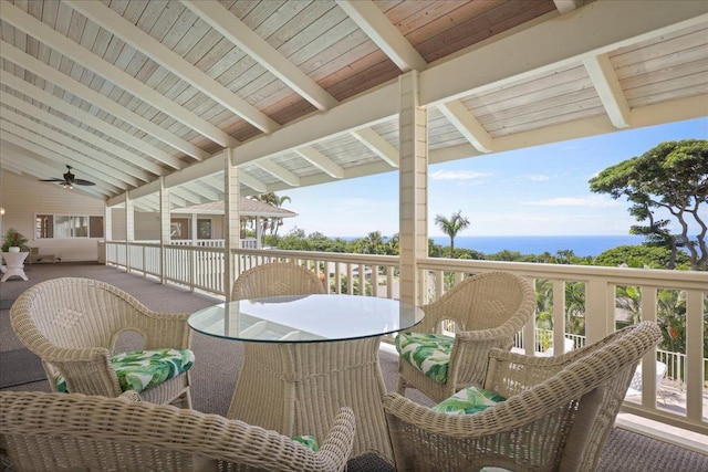 exterior space with ceiling fan and a water view