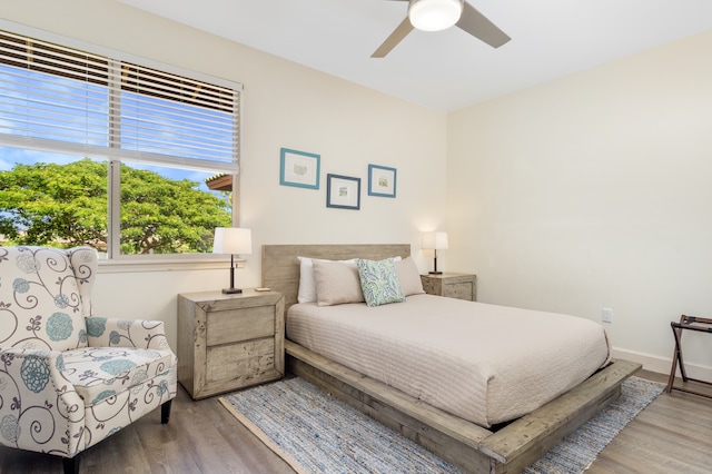 bedroom with wood-type flooring and ceiling fan