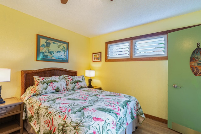 bedroom featuring ceiling fan and hardwood / wood-style flooring