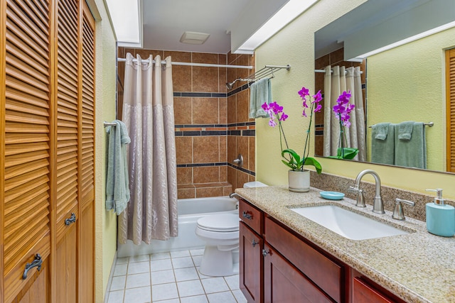 full bathroom featuring tile patterned floors, vanity, toilet, and shower / bathtub combination with curtain