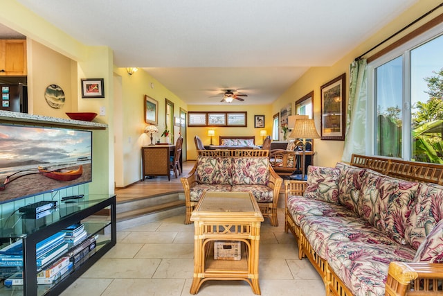 tiled living room with ceiling fan