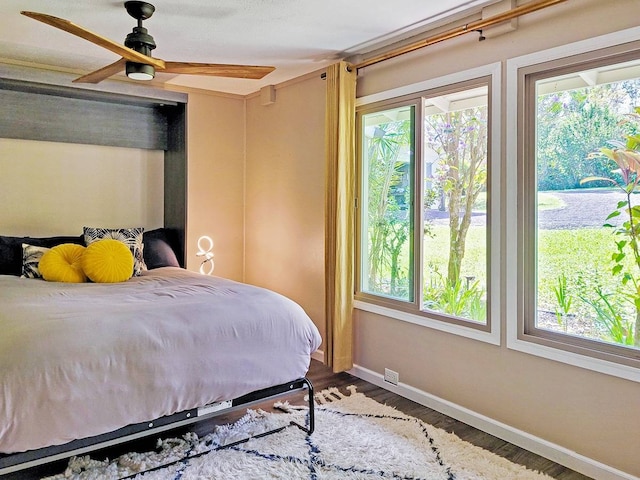 bedroom with hardwood / wood-style flooring and ceiling fan