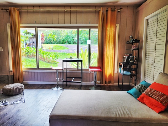 bedroom featuring hardwood / wood-style floors and wooden walls