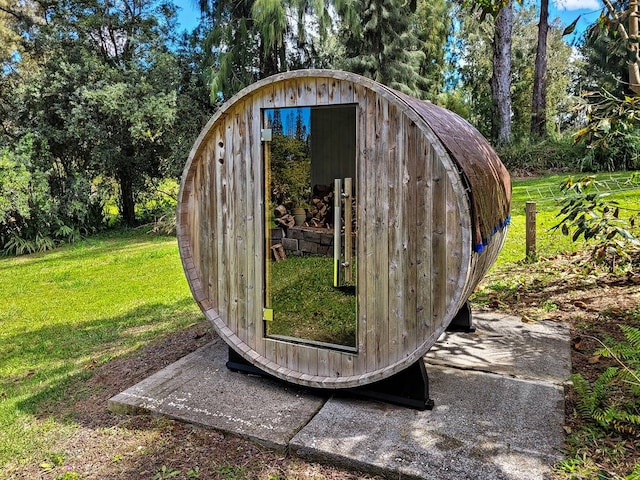 view of outdoor structure featuring a lawn