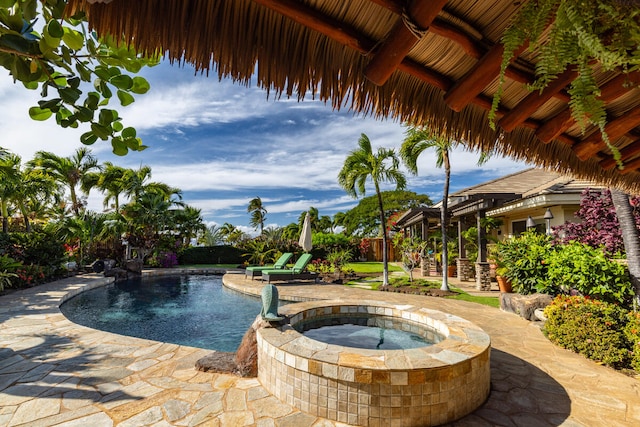 view of swimming pool with an in ground hot tub and a patio