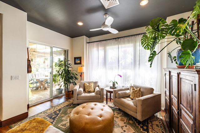 sitting room featuring wood-type flooring, ceiling fan, and a healthy amount of sunlight