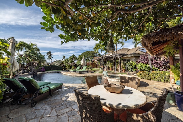 view of patio with a pool with hot tub